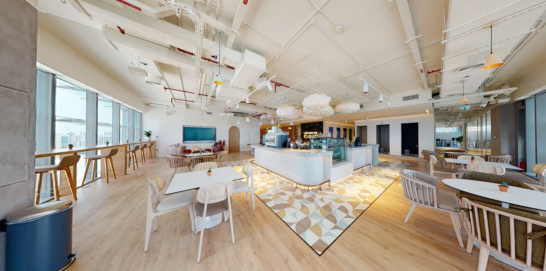 Modern coworking space at Cloud Spaces ADGM, Abu Dhabi, with seating areas.