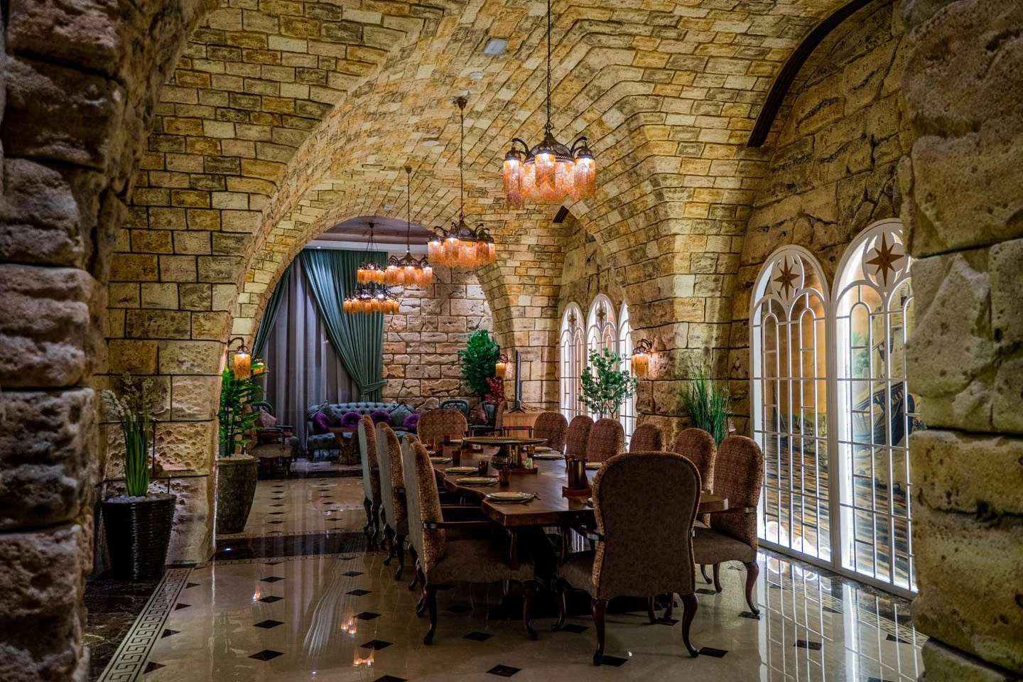 Elegant dining area in Al Meshwar Restaurant, Dubai with stone arches.