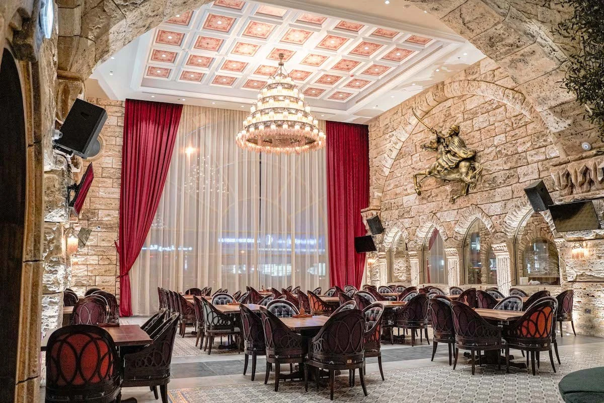 Elegant dining area at Al Meshwar Restaurant Dubai with chandelier.