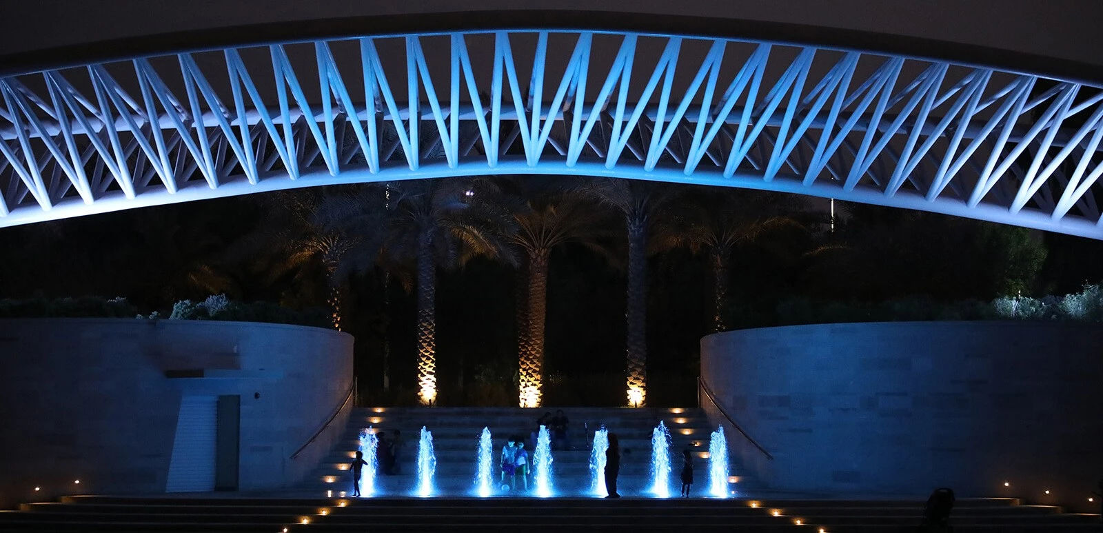 Illuminated amphitheatre with fountains at Umm Al Emarat Park, Abu Dhabi.