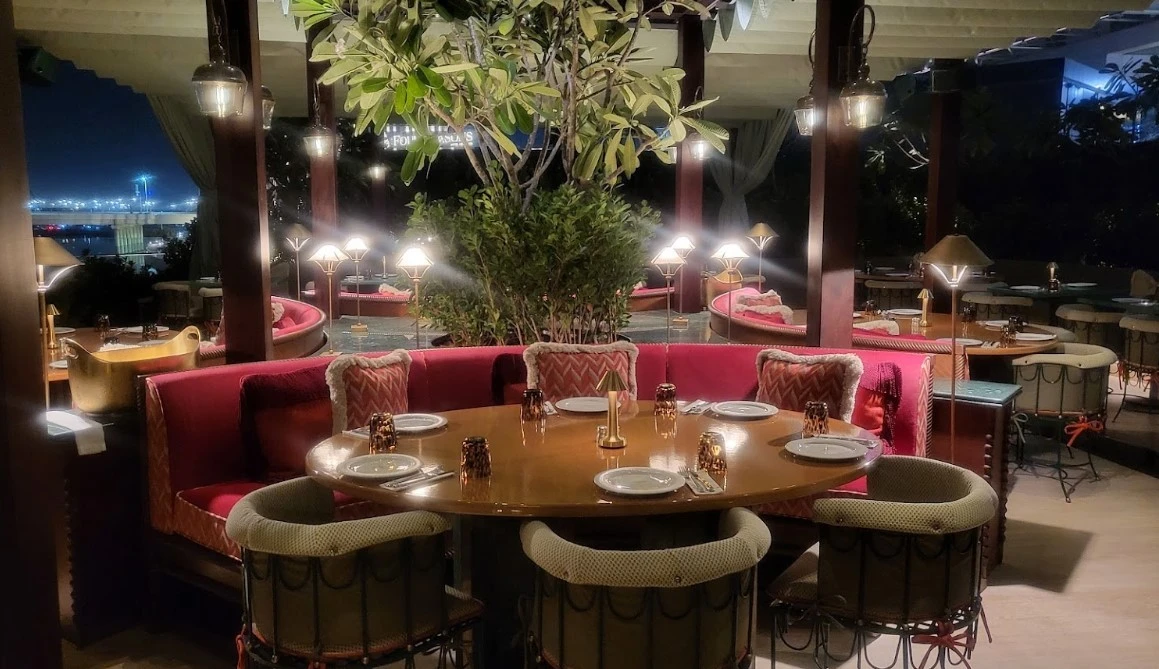 Cozy round table with ambient lighting at Flamingo Room, Abu Dhabi.