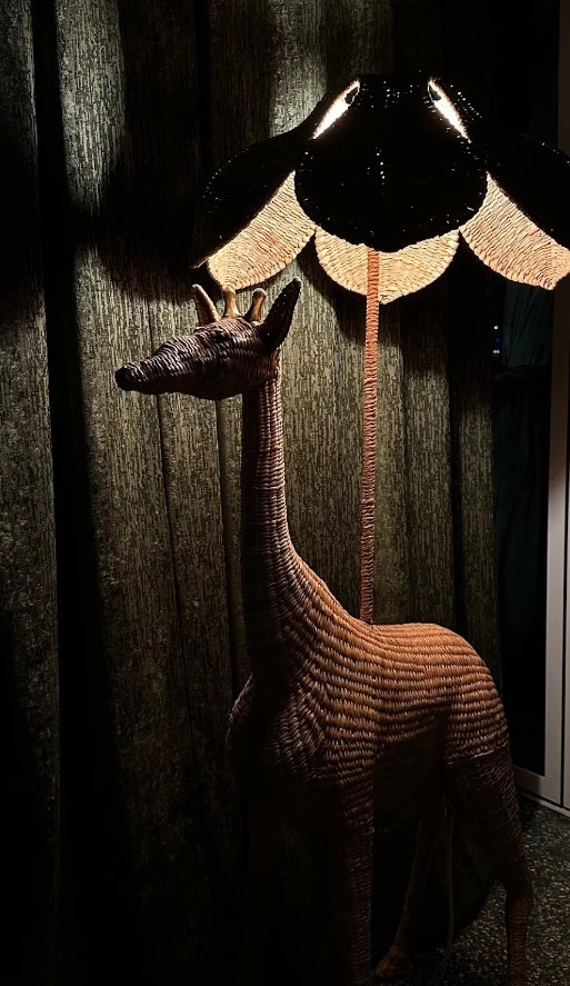 Giraffe-shaped lamp in Flamingo Room by tashas, Abu Dhabi.