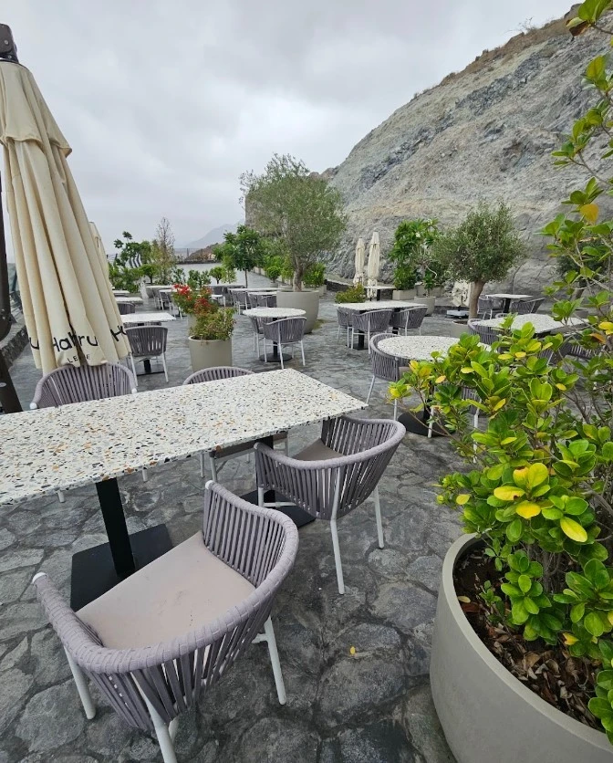 Outdoor seating at Habib Beirut Restaurant Khorfakkan, Sharjah, with mountain view.