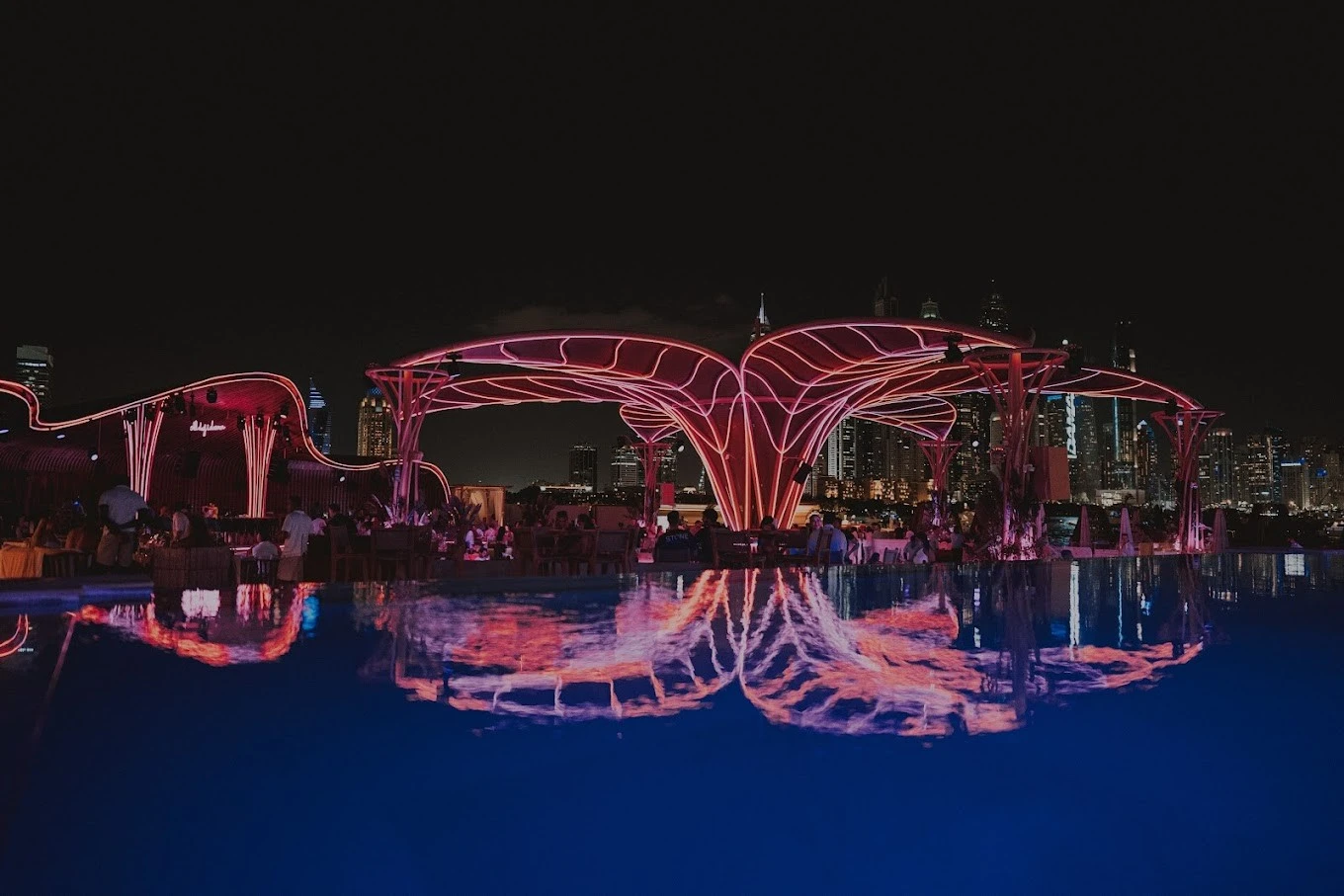 Bohemia Beach Club Dubai at night with illuminated structures.