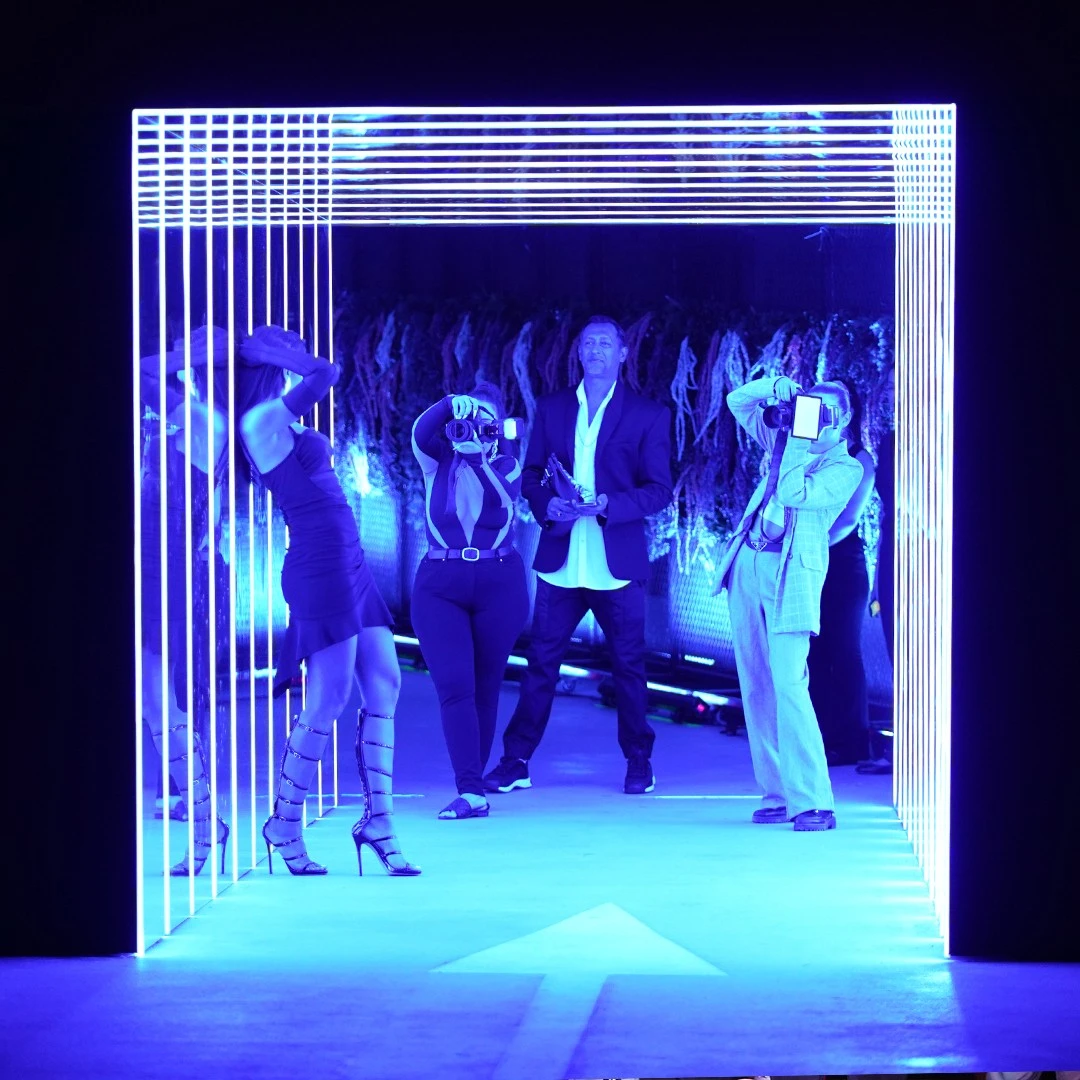 People posing under blue neon lights at P7 Arena, Dubai.