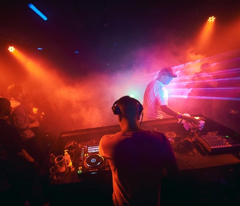 DJ performing at P7 Arena, Dubai with colorful lights.