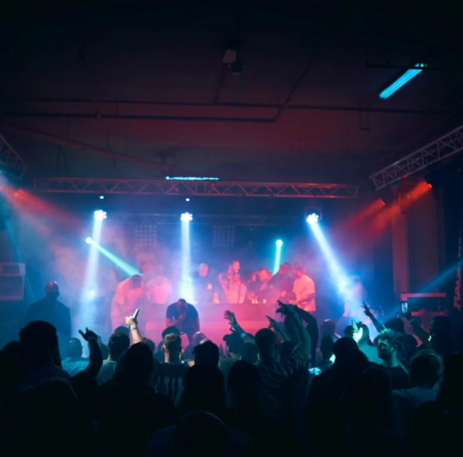 Crowd enjoying concert at P7 Arena, Dubai with colorful stage lights.