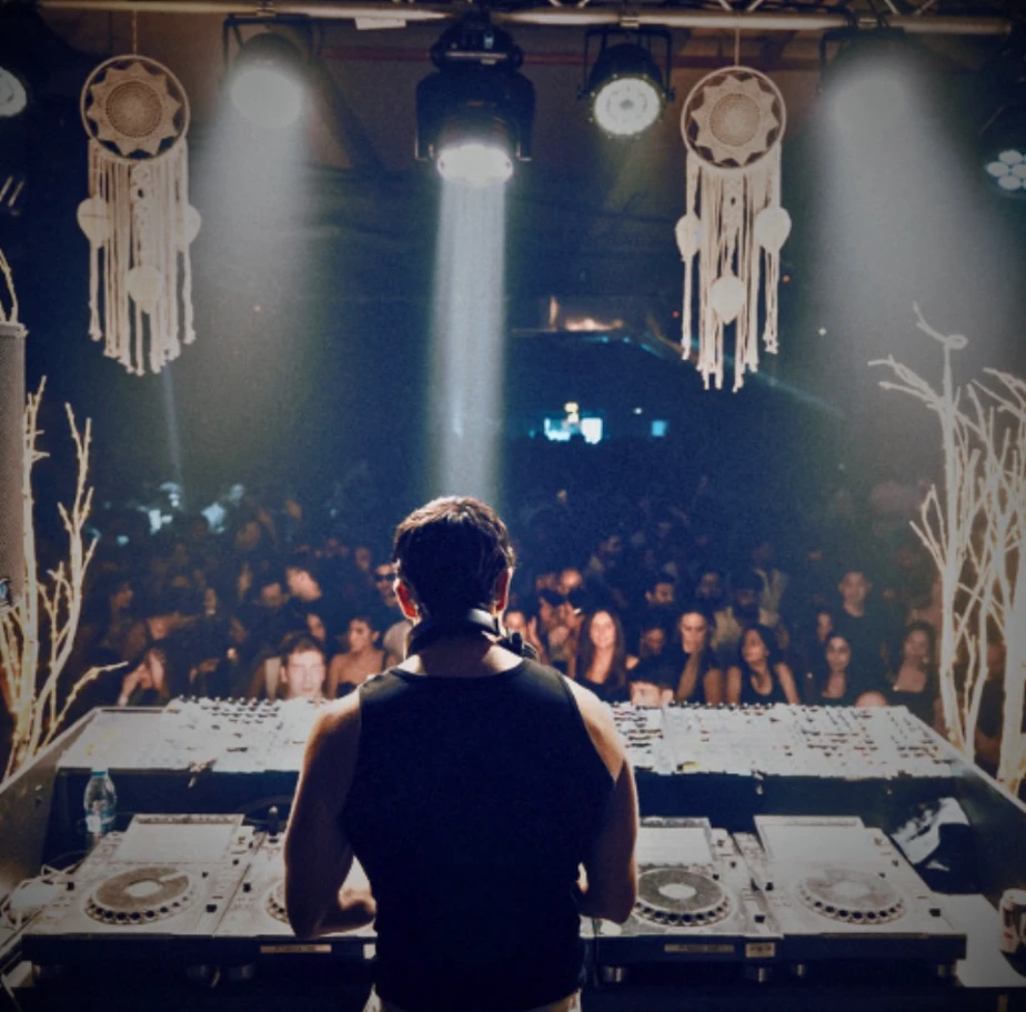 DJ performing at P7 Arena, Dubai, with crowd and dreamcatchers.