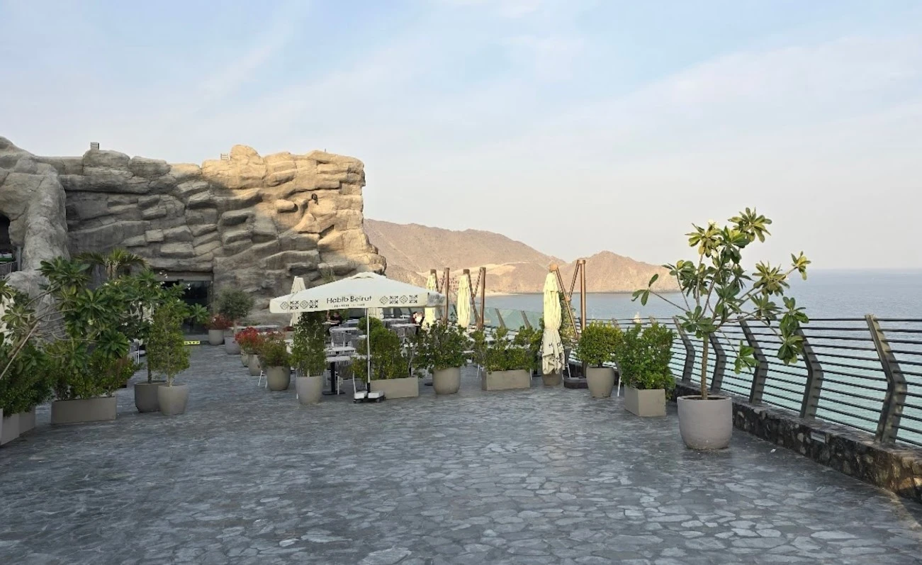 Outdoor terrace at Habib Beirut Restaurant, Khorfakkan, overlooking the sea.