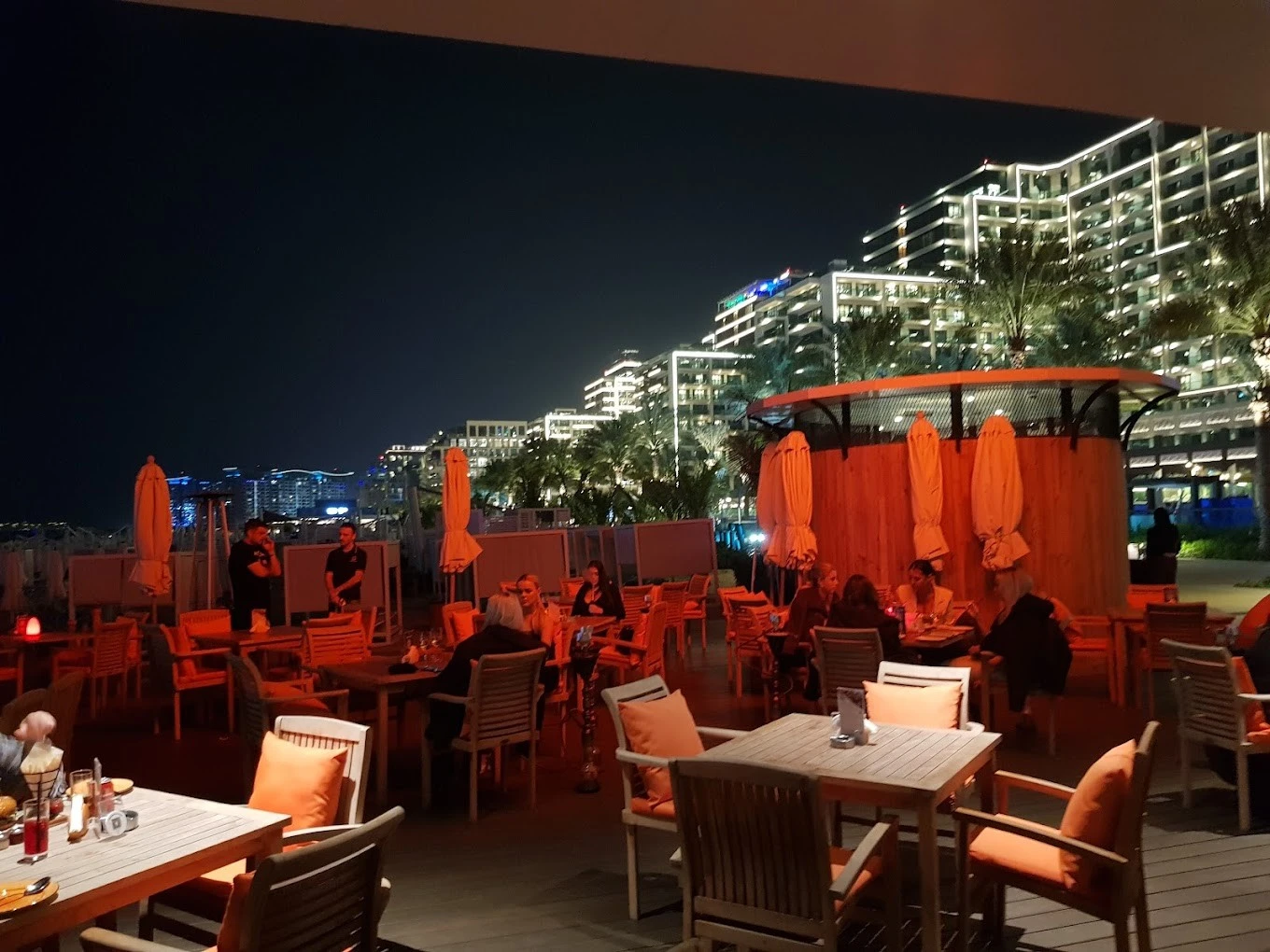 Outdoor dining at Orange Chameleon Restaurant & Lounge, Dubai, night view.