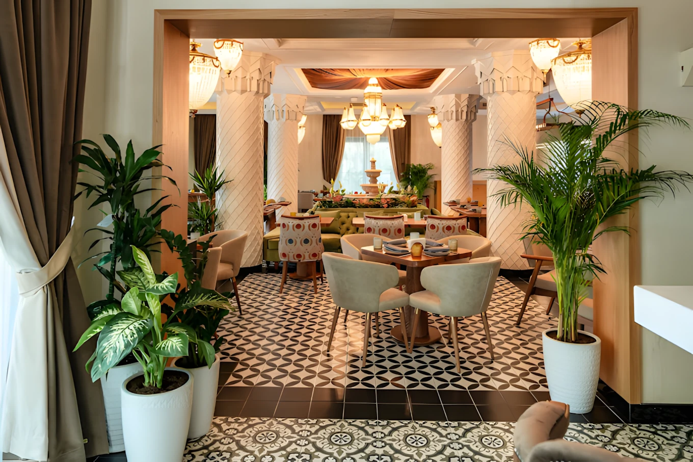 Elegant dining area at Grand Zor Restaurant, Dubai with lush plants.
