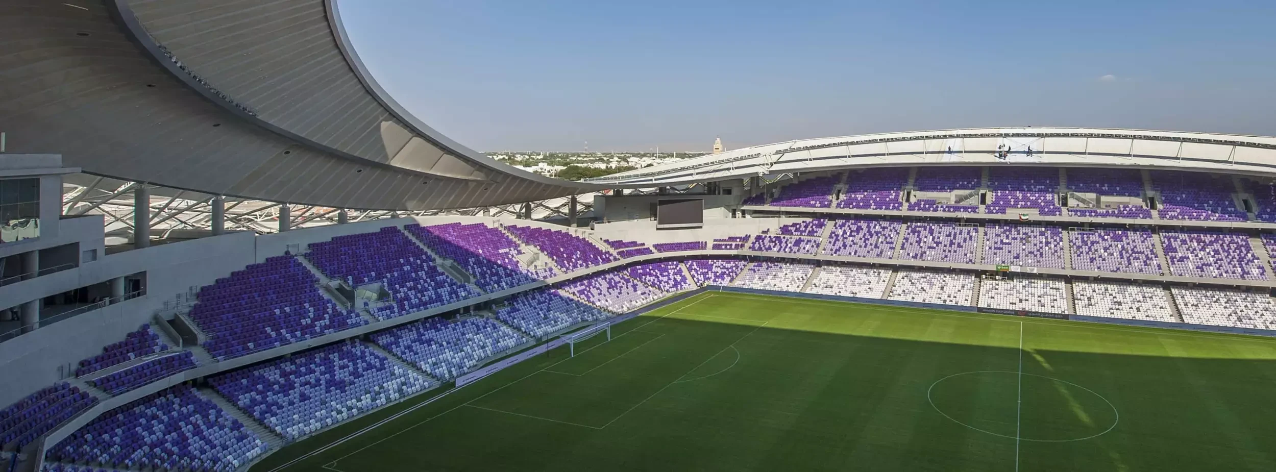 Hazza Bin Zayed Stadium with empty purple and white seats, Al Ain.
