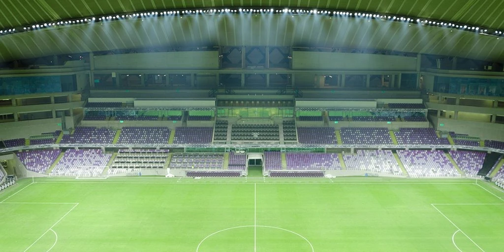 Empty Hazza Bin Zayed Stadium with green field, Al Ain.