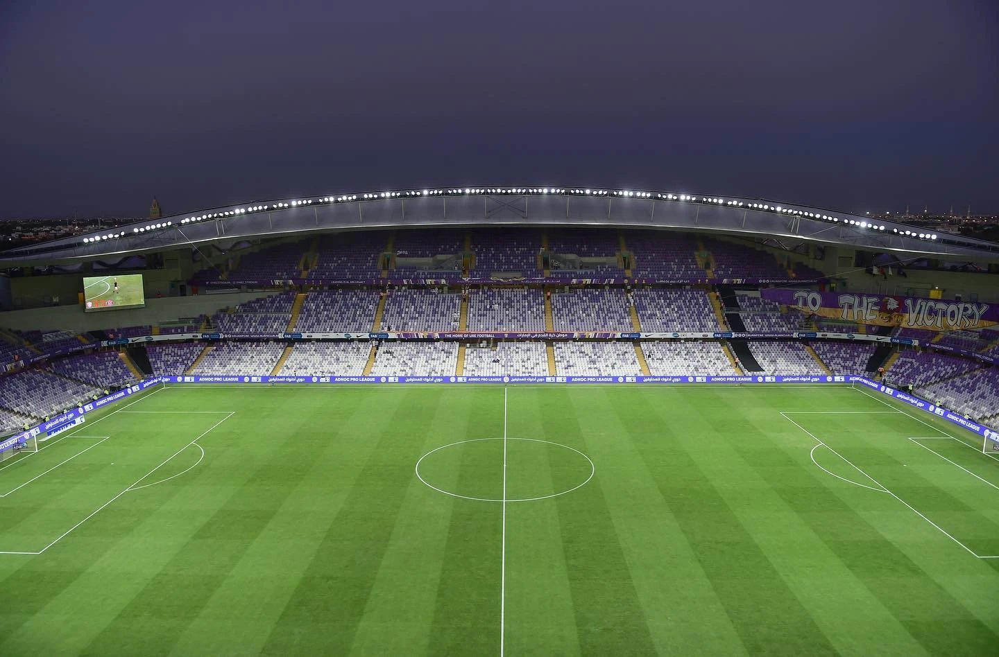 Empty Hazza Bin Zayed Stadium in Al Ain at dusk.