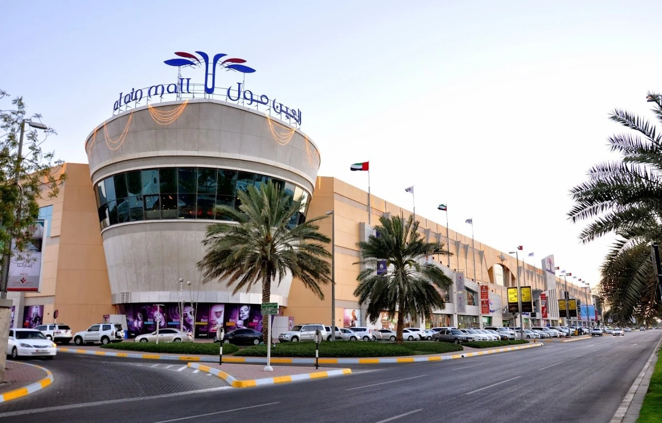 Star Cinemas Al Ain Mall exterior, palm trees, parked cars, Al Ain.