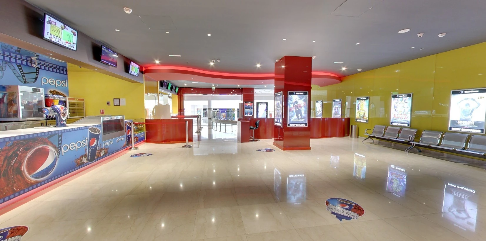Star Cinema Barari Outlet Mall lobby, Al Ain, with seating and posters.