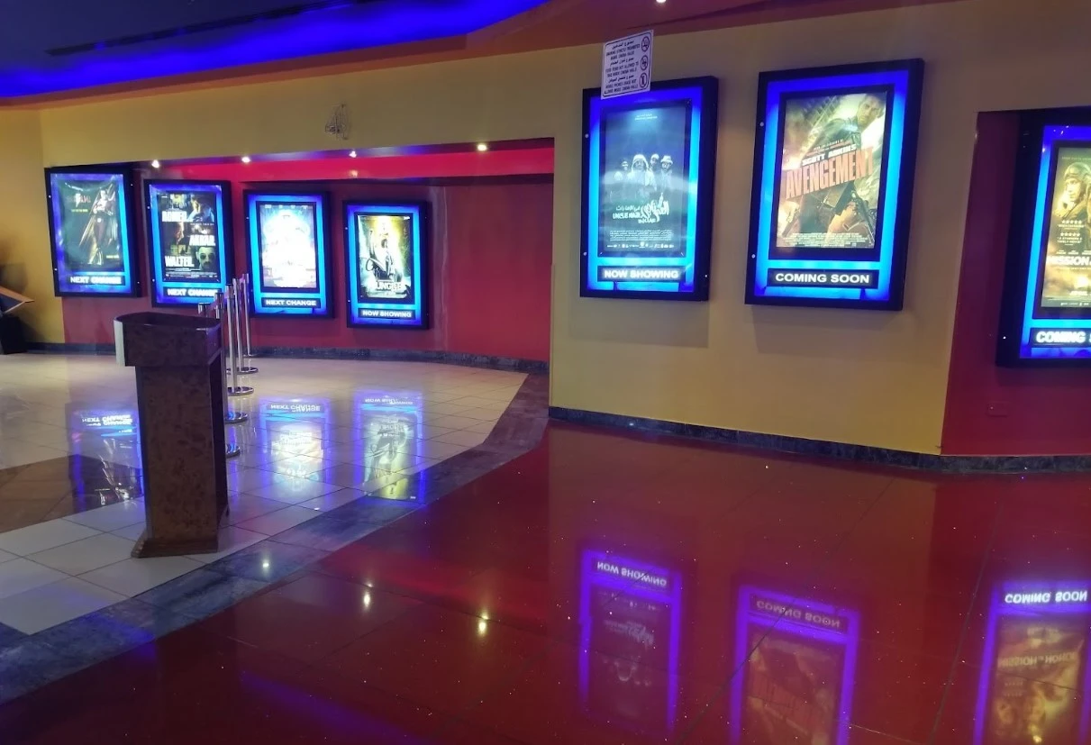 Star Cinemas Al Ain Mall movie posters in illuminated frames.