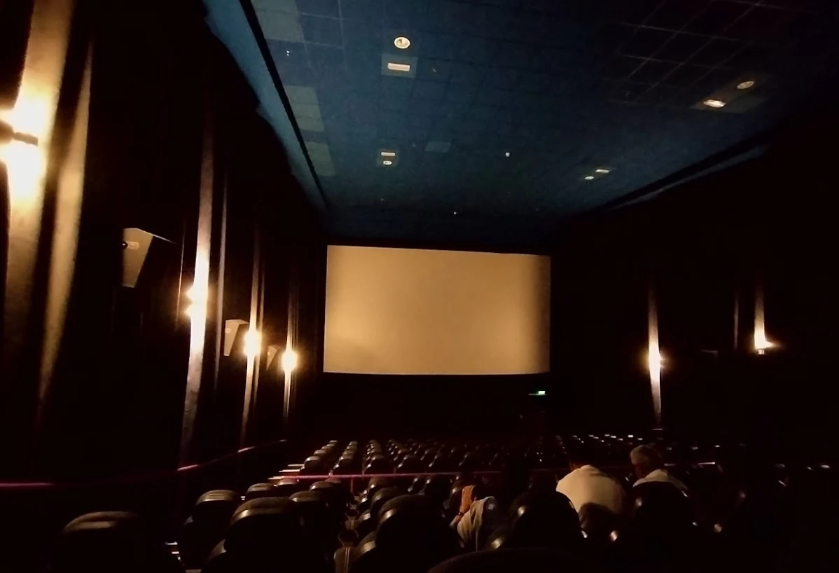 Dimly lit cinema with empty seats, Star Cinemas Al Ain Mall.