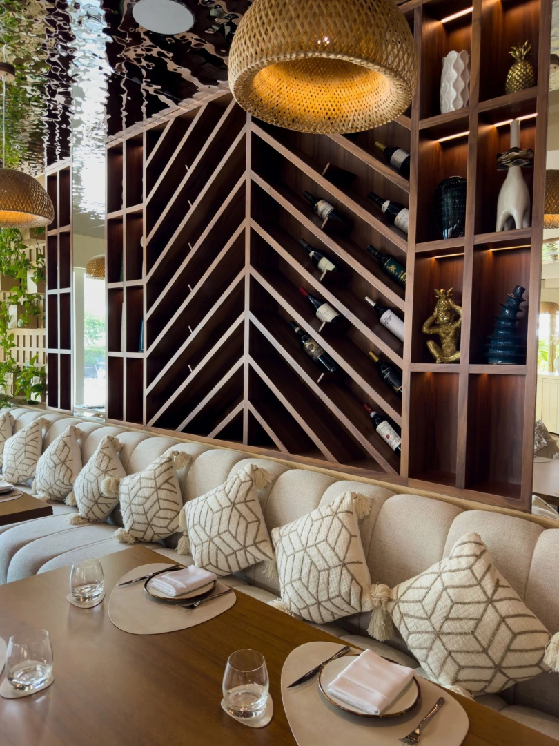 Luxurious dining setup with patterned cushions at Cabana On The Beach.