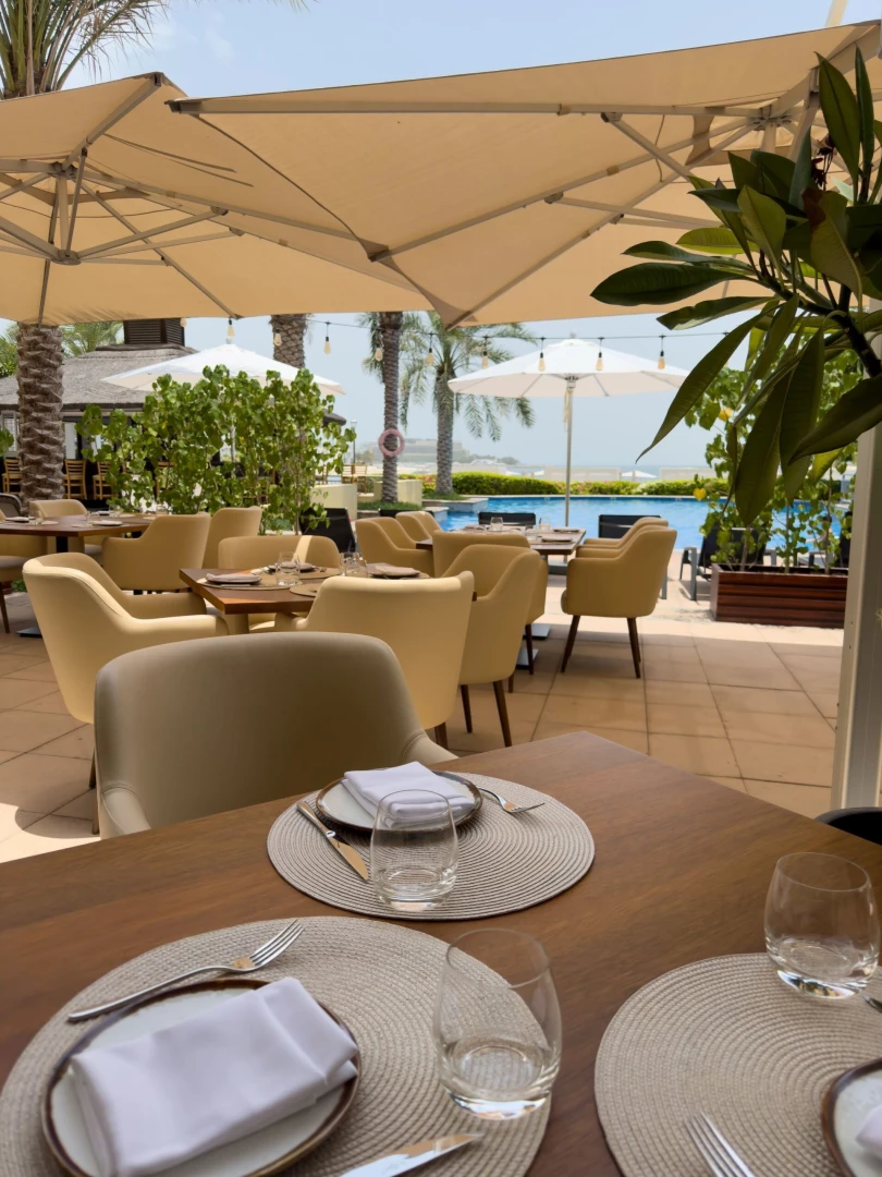 Outdoor dining at Cabana On The Beach, Palm Dubai with sea view.
