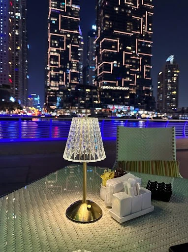Elegant table setting at ILOLI, Dubai Marina Walk, night skyline view.
