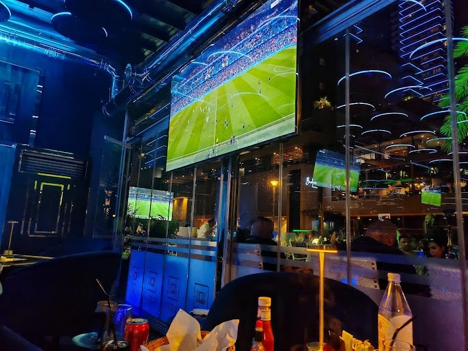 ILOLI restaurant interior with sports game on TV, Dubai Marina.