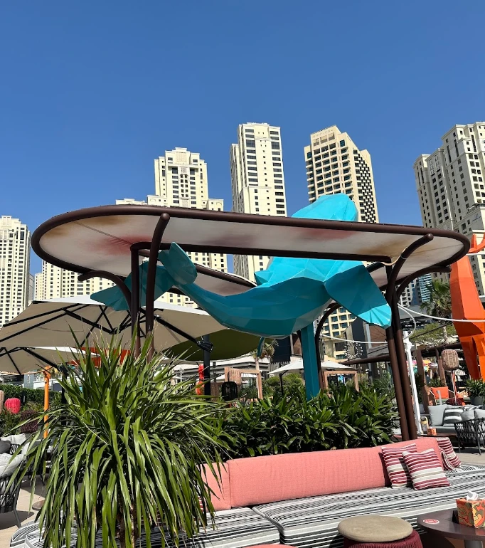 Yula Lounge outdoor seating with skyscrapers, Dubai skyline in background.