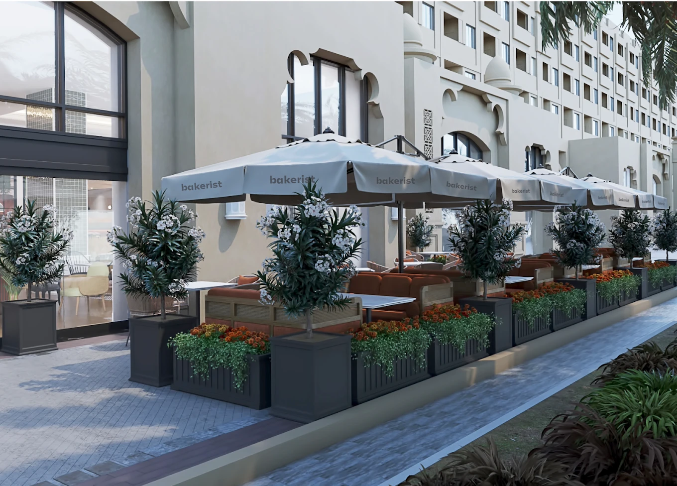 Outdoor seating at Bakerist The Palm Jumeirah, Dubai with umbrellas.