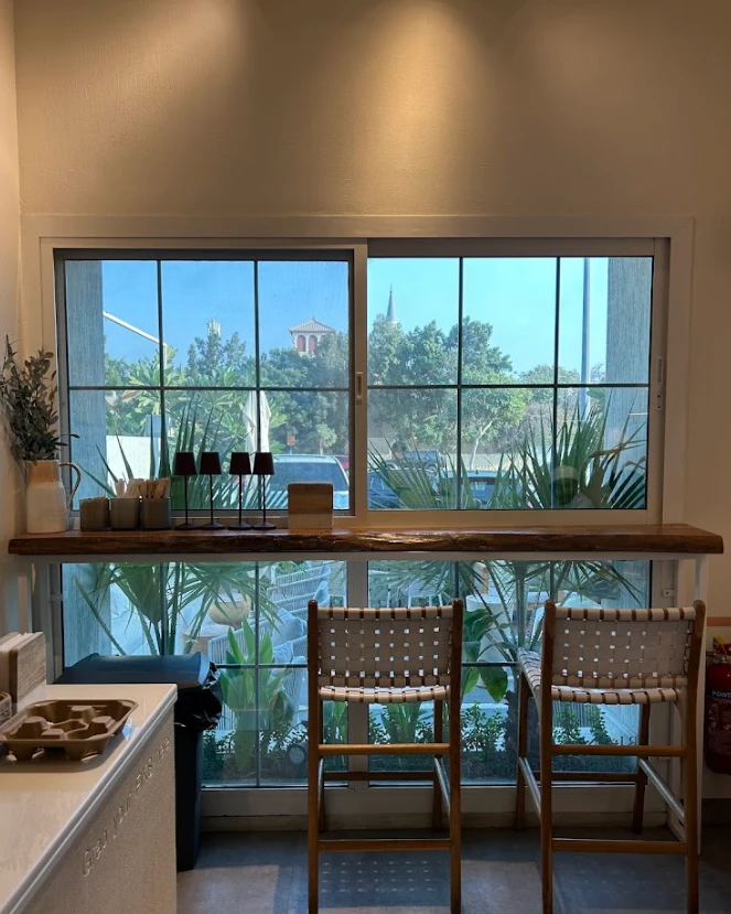 Cozy seating by window at Fiks Coffee Umm Suqeim, Dubai.