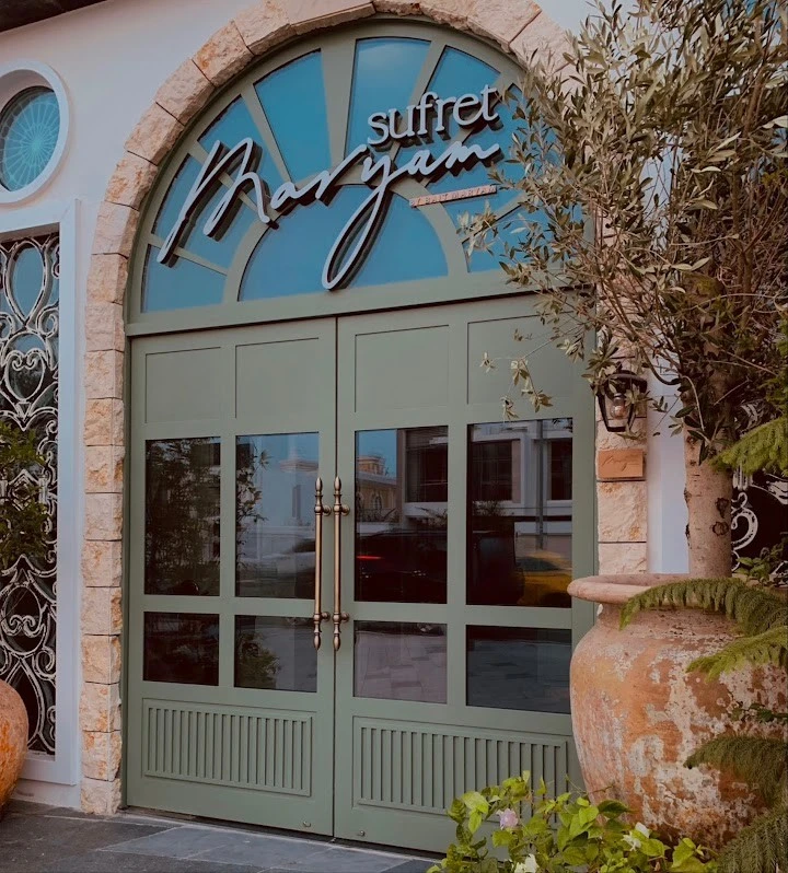 Entrance of Sufret Maryam Restaurant, Dubai Al Wasl, with greenery.