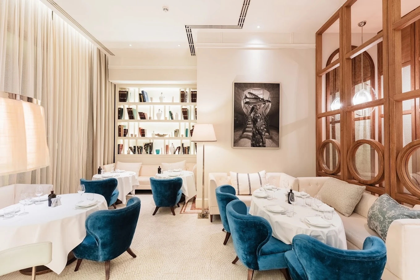 Elegant dining area at Gaia Dubai with blue chairs.