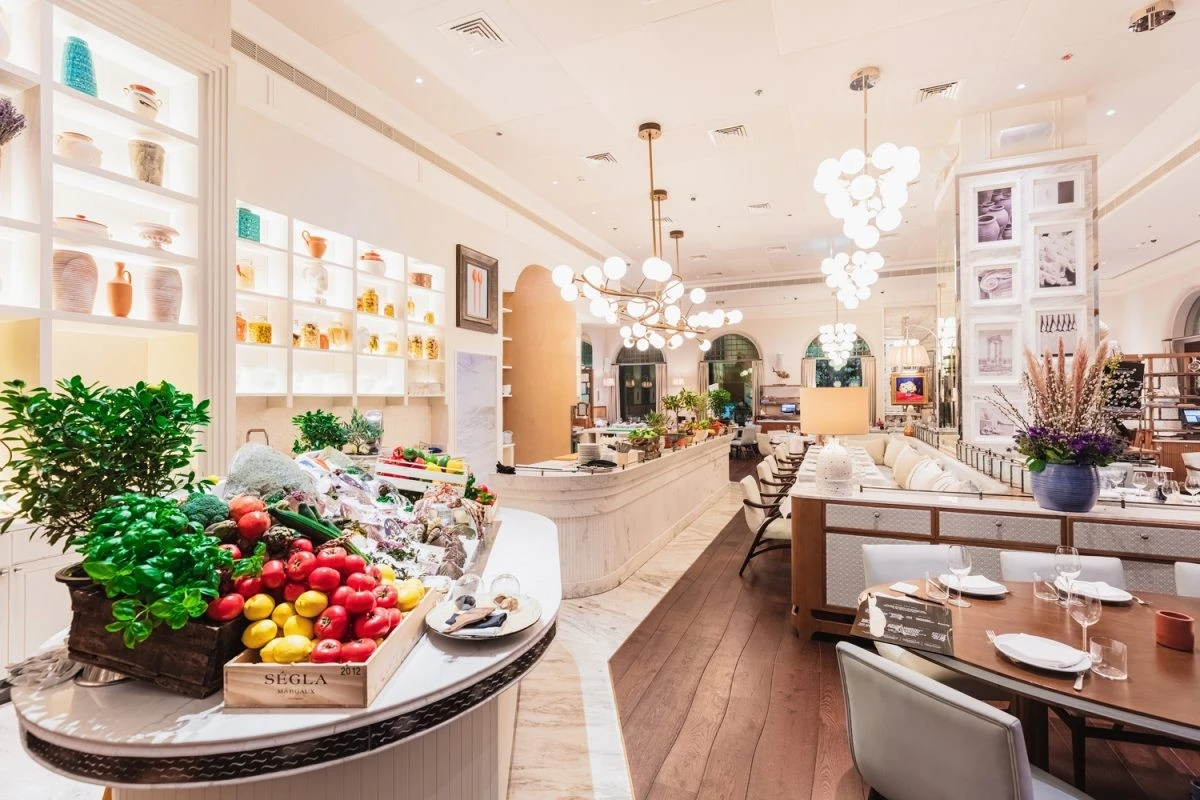 Elegant interior of Gaia Dubai restaurant with fresh produce display.