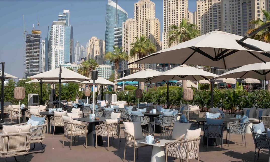 Outdoor seating at Yula Lounge, Dubai with city skyline view.