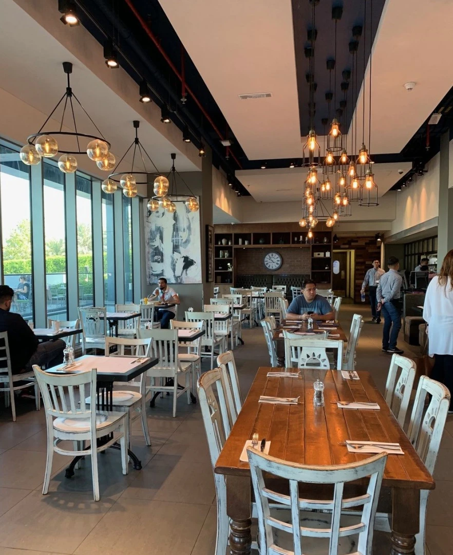 Eggspectation Restaurant Cafe interior with wooden tables, Dubai Marina.