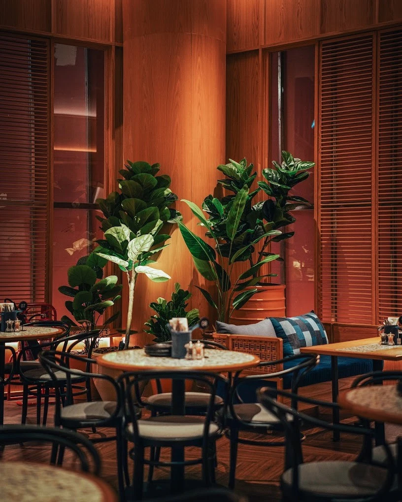 Cozy dining area with plants, Social House Restaurant Dubai.