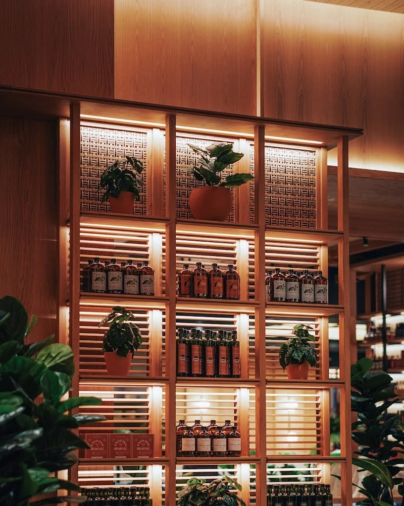 Wooden shelves with plants and bottles, Social House Restaurant Dubai.