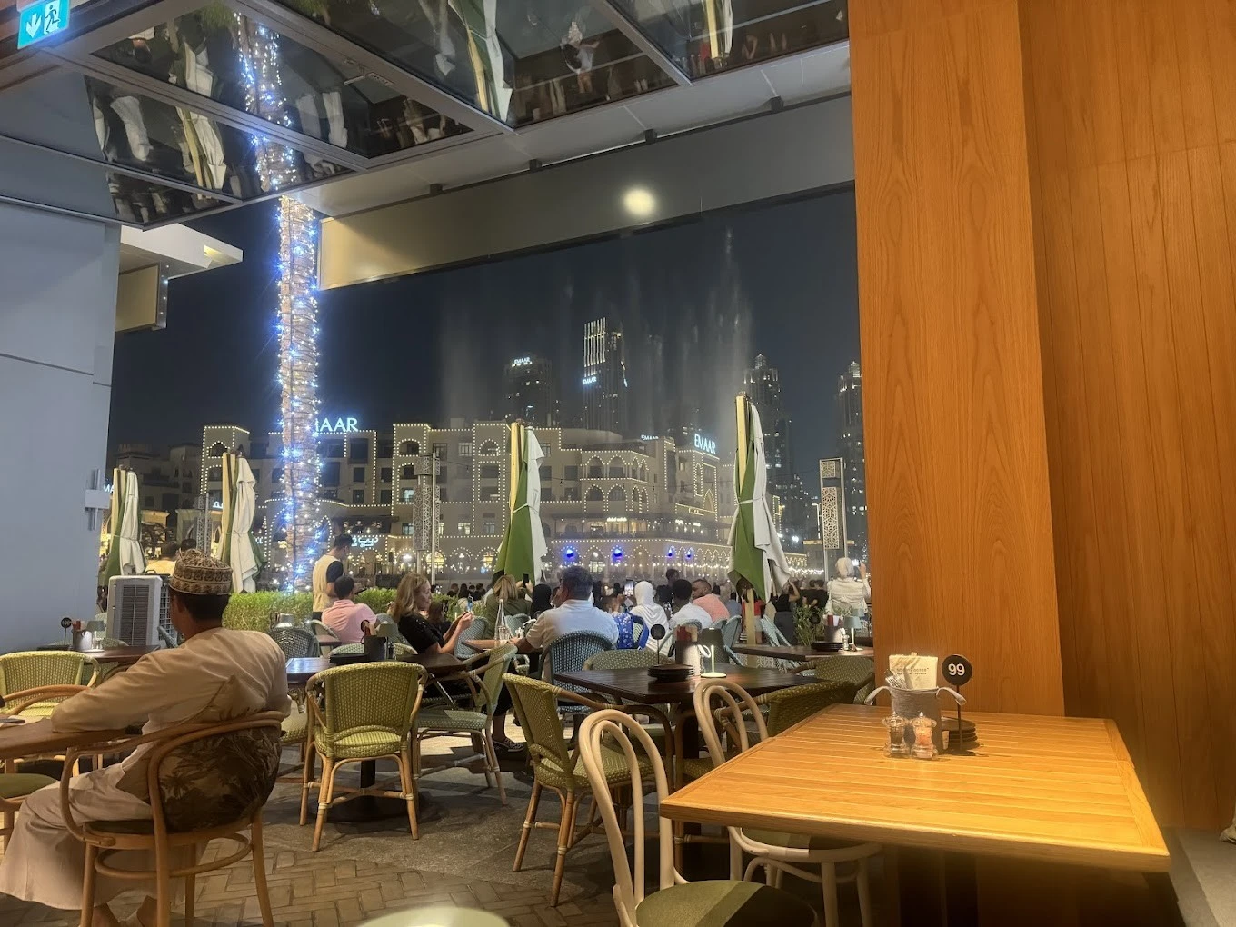 Social House Restaurant Dubai outdoor dining with city skyline view.