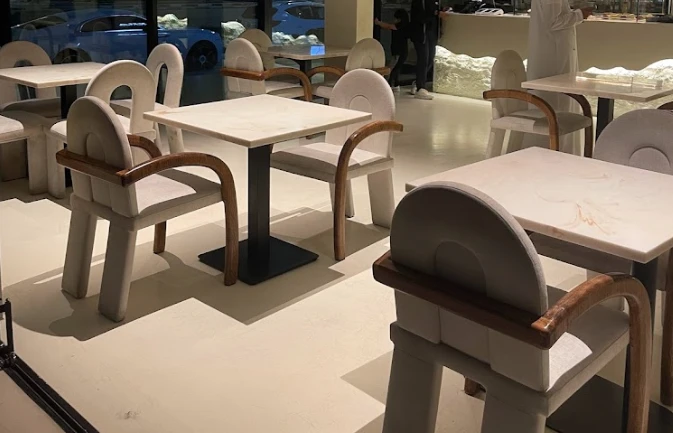 Modern seating area at Lune Lounge, Dubai with stylish chairs and tables.