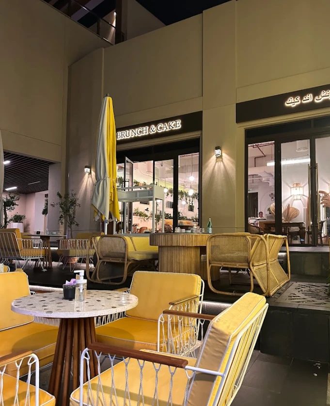 Outdoor seating at Brunch & Cake Wasl 51, Dubai, evening ambiance.