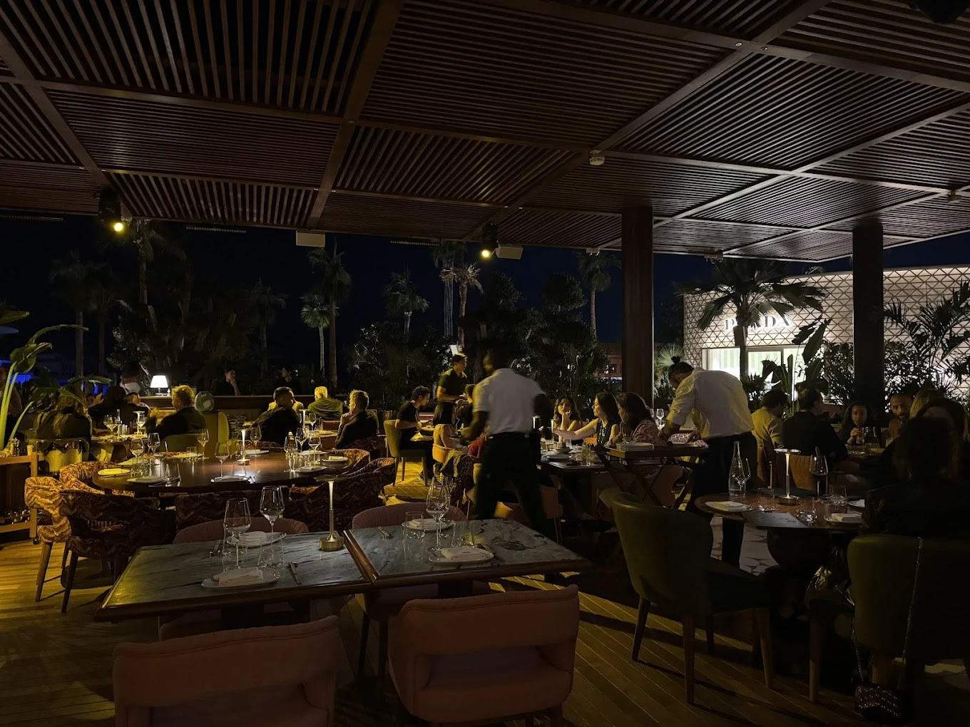 Evening dining at Baoli Restaurant Dubai with patrons and waitstaff.