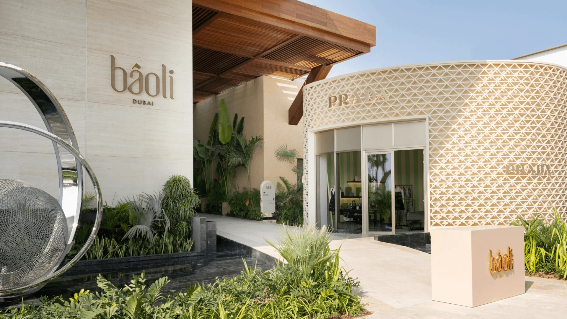 Baoli Restaurant Dubai entrance with modern design and greenery.