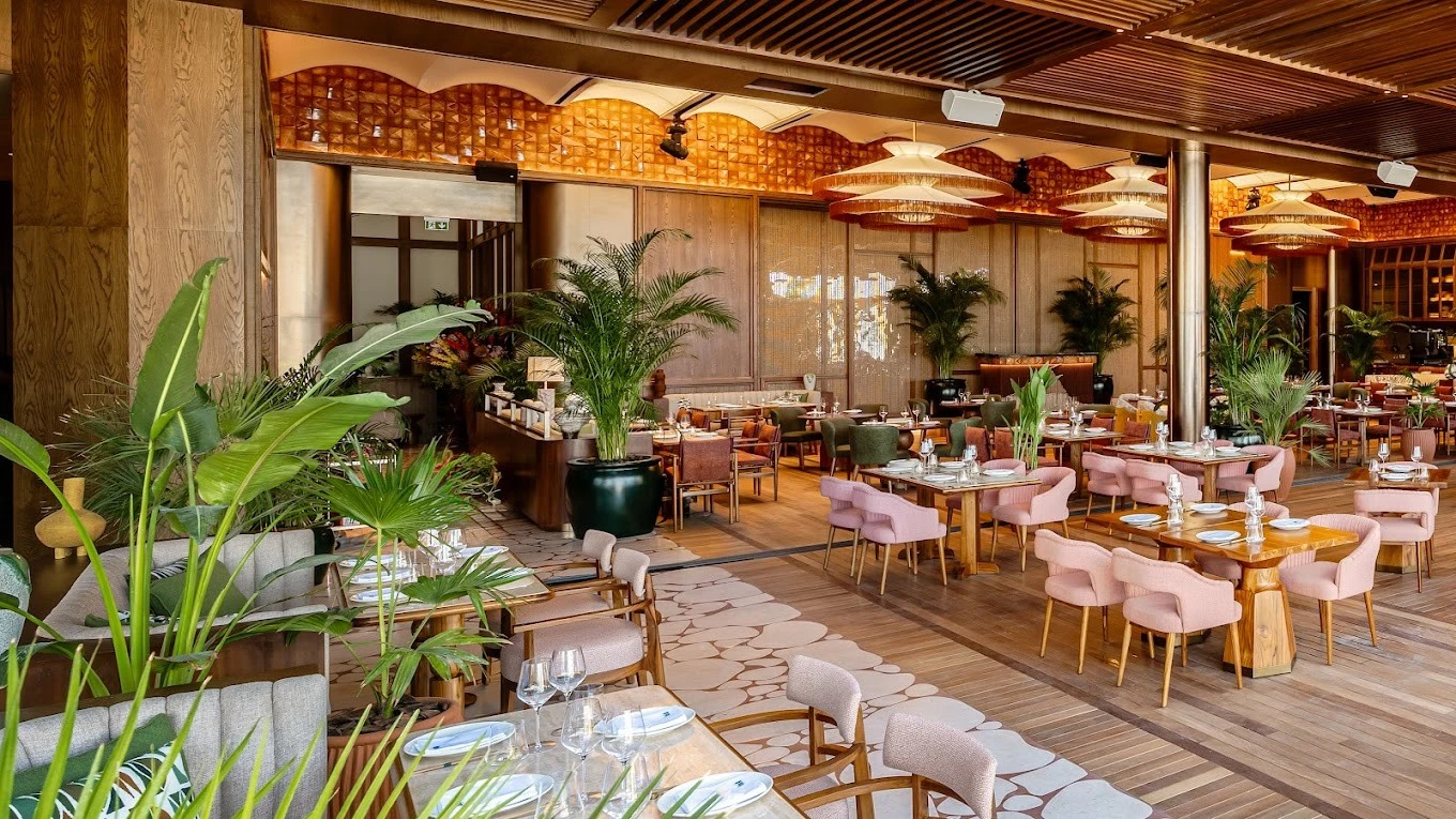 Elegant dining area at Baoli Restaurant Dubai with lush greenery.