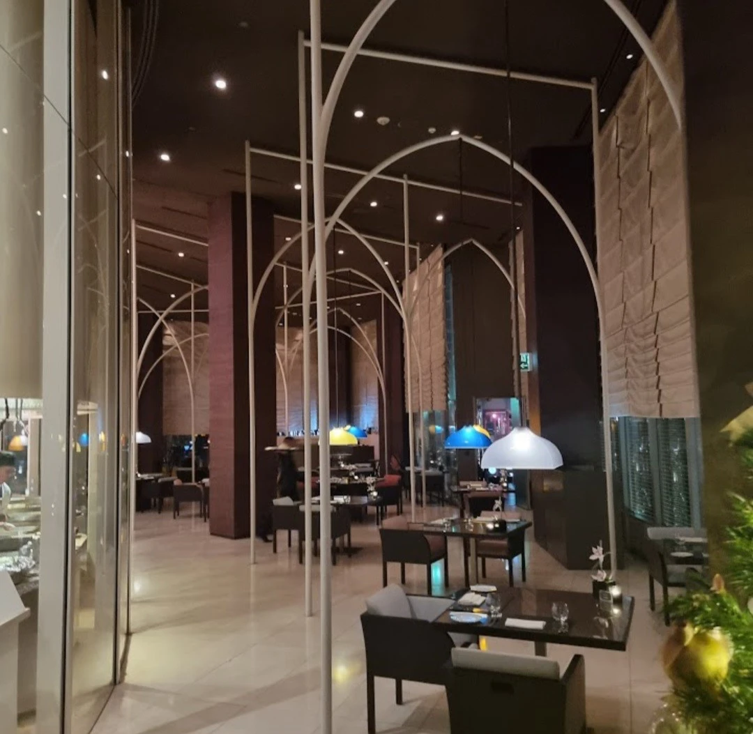 Contemporary dining area with colorful pendant lights, Amal Restaurant, Dubai.
