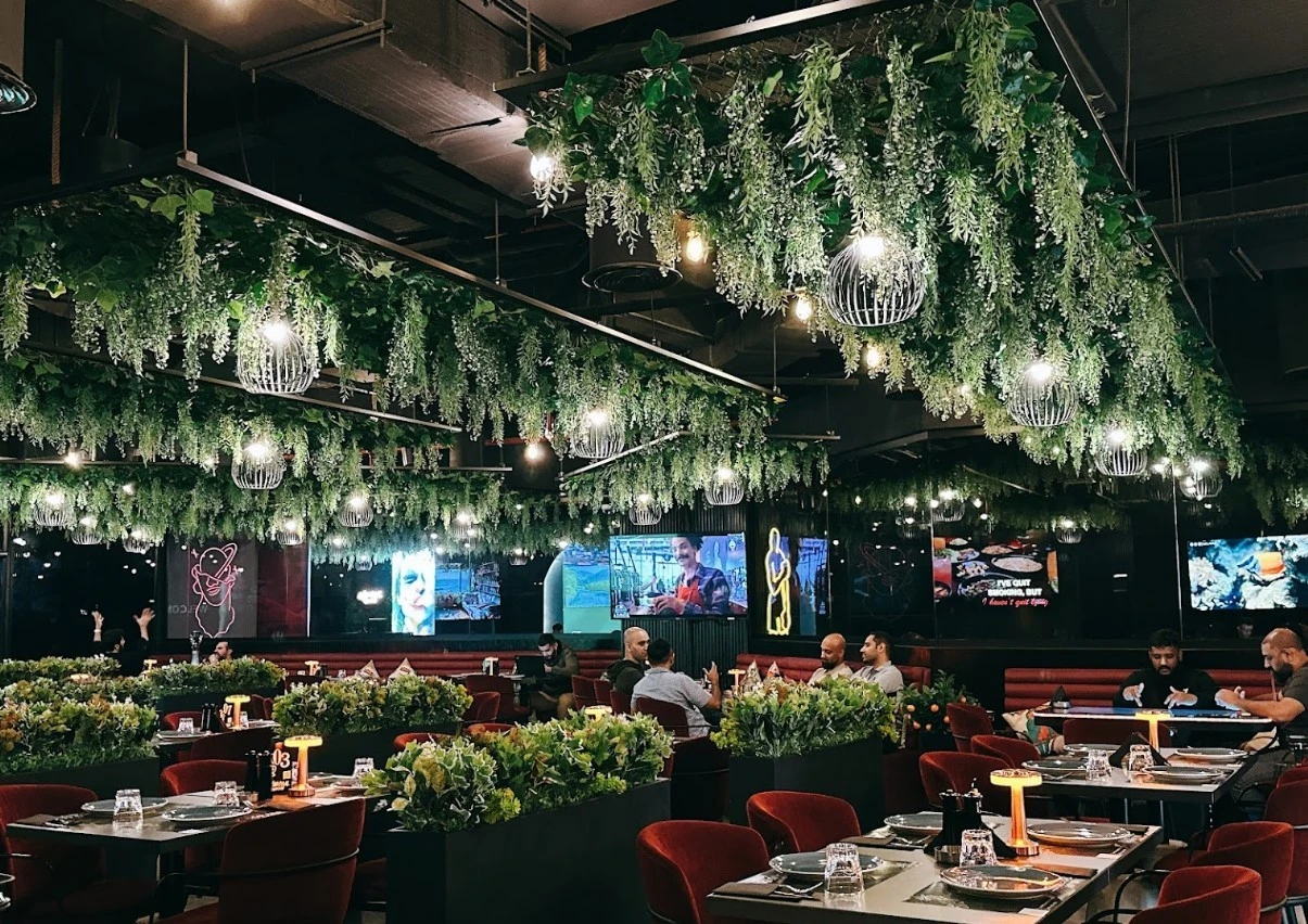 Lush greenery decor at Charcoal Garden Restaurant, Dubai Media City.