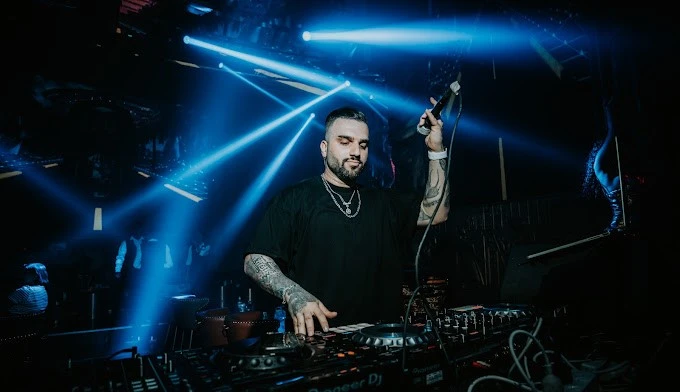 DJ performing at Vice Night Club Downtown Dubai with vibrant lights.