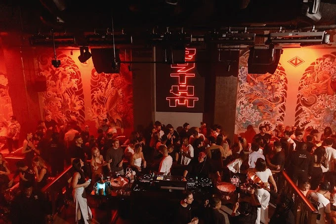 Crowded Secret Room Downtown Dubai with vibrant red lighting and decor.