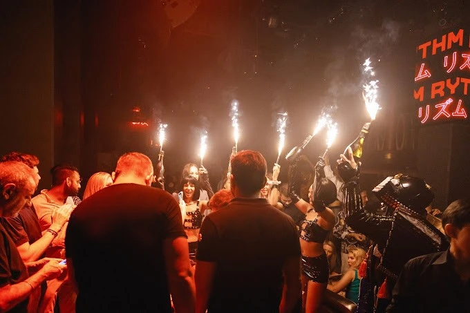 Crowded party at Secret Room Downtown Dubai with sparklers.