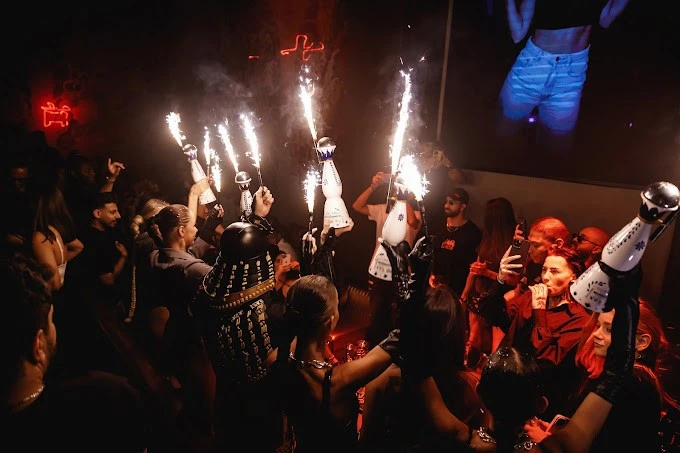 Crowd celebrating with sparklers at Secret Room Downtown Dubai.