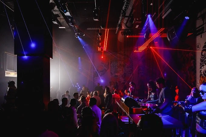 Crowded nightclub with vibrant lights at Secret Room Downtown Dubai.