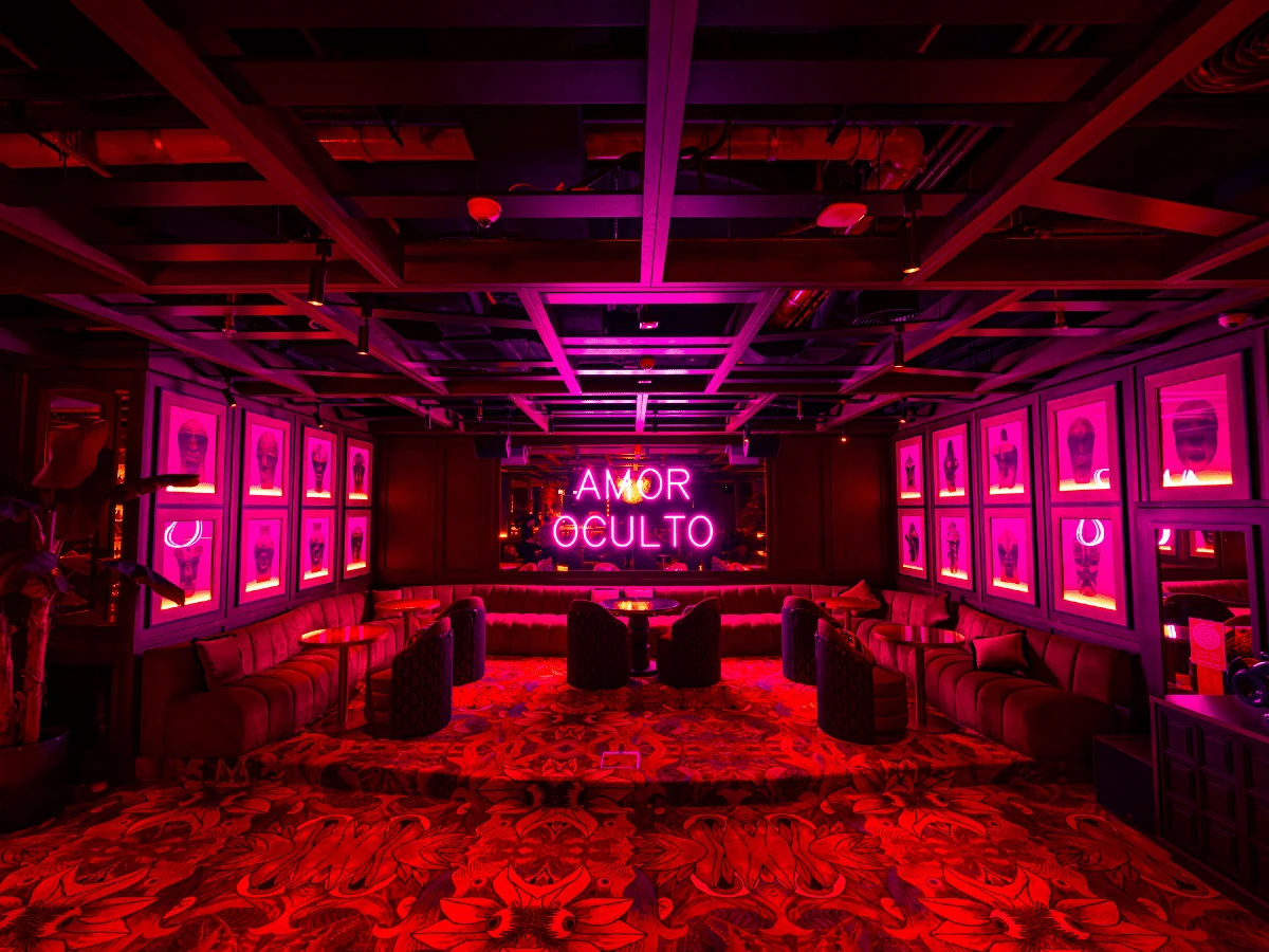 Vibrant interior of Amor by Salvaje, Downtown Dubai with neon lights.